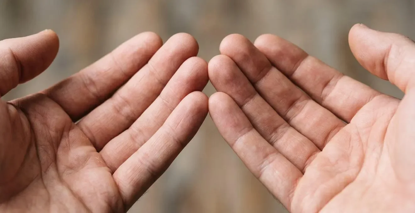 Close-up of hands in a meditative position representing self-regulation and biofeedback practice